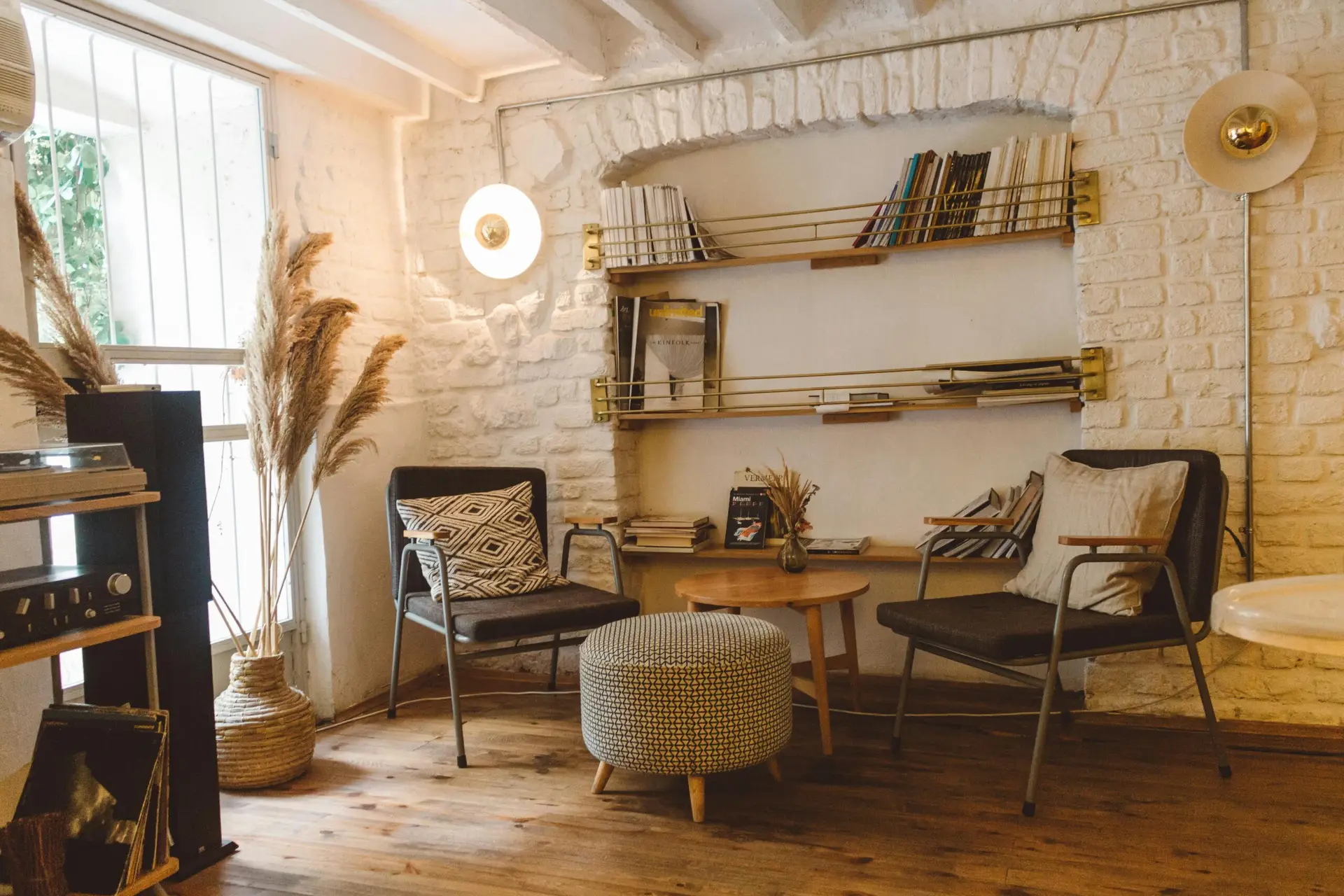 pexels-photo-2079246-2079246 Inviting modern rustic living room featuring armchairs, an ottoman, and a stylish bookshelf.